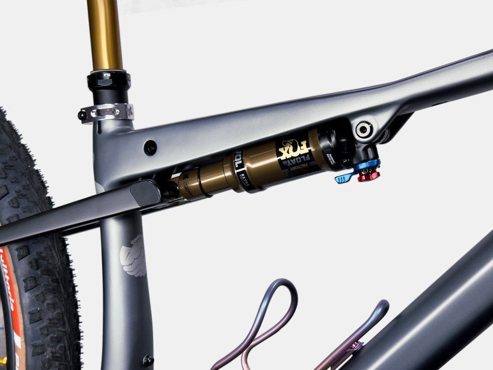 Close-up of a bicycle rear suspension shock on a white background