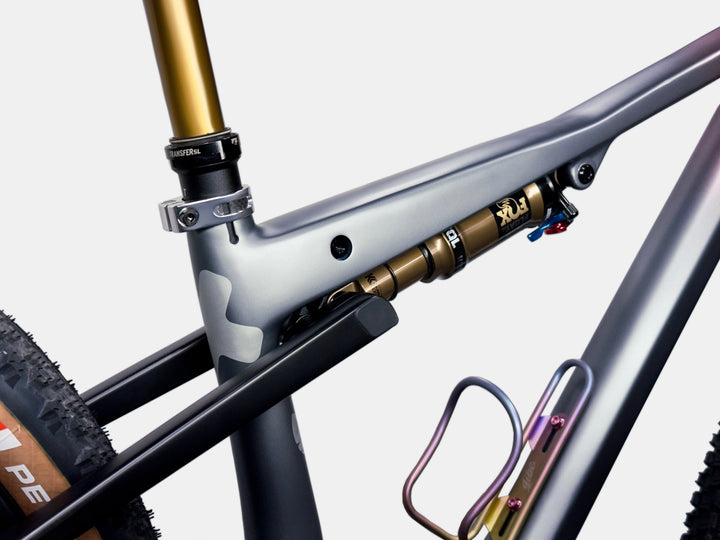Close-up of a grey and black bicycle frame with a rear suspension shock on a white background