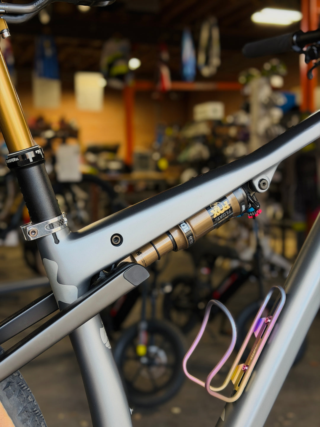 Close-up of a bicycle frame with a workshop in the background